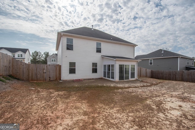 rear view of property featuring a sunroom