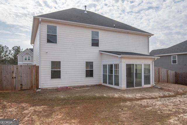 back of property with a sunroom