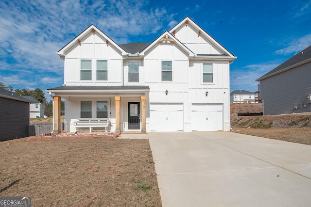 view of front of property featuring a garage, covered porch, and a front lawn