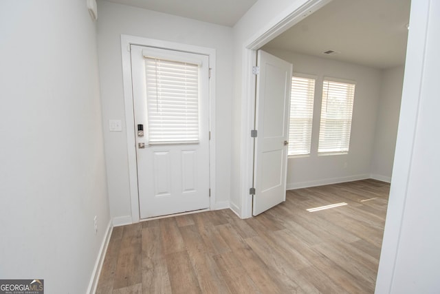 doorway to outside with light wood-type flooring