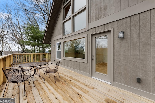 wooden terrace with outdoor dining space