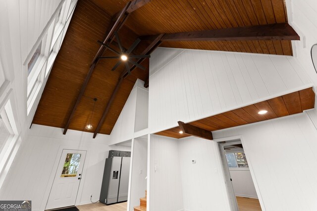 room details featuring wood ceiling, stainless steel fridge with ice dispenser, and beamed ceiling