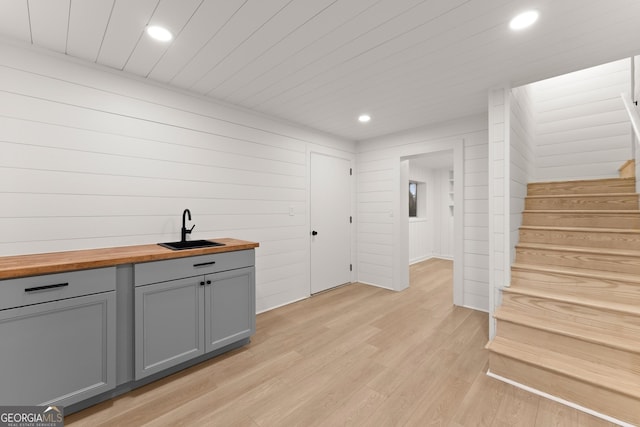 291 Saddleback Cir, Sky Valley, GA 30537 - bar area featuring light wood-style floors, recessed lighting, stairs, and wood walls