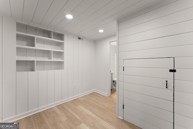 unfurnished room with light wood-type flooring, baseboards, visible vents, and recessed lighting