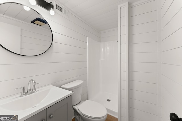 full bathroom with toilet, vanity, a shower stall, and visible vents