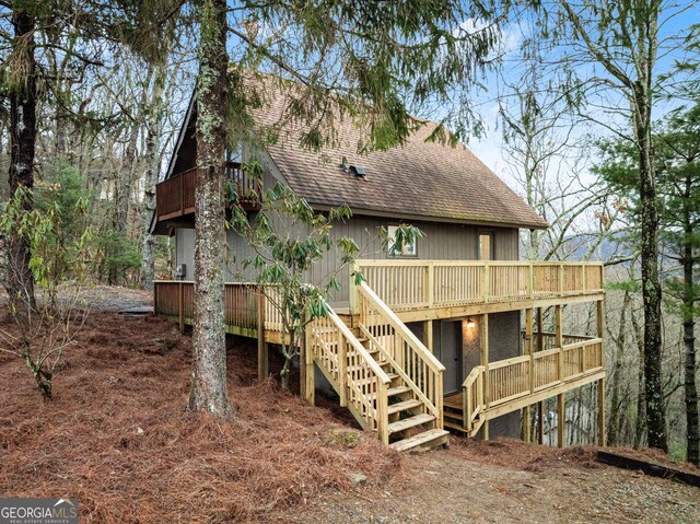 rear view of house featuring a deck