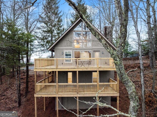 rear view of house featuring a deck