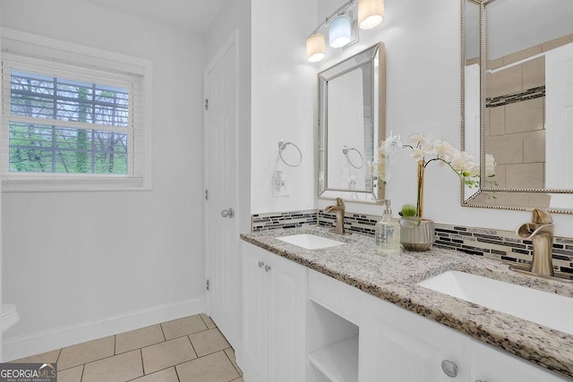 bathroom with tile patterned floors, vanity, and backsplash