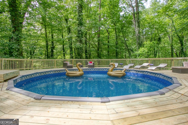 view of pool with a wooden deck