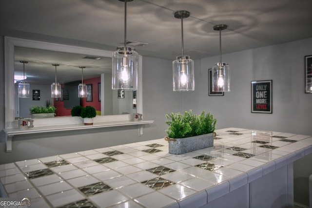 kitchen featuring kitchen peninsula and decorative light fixtures