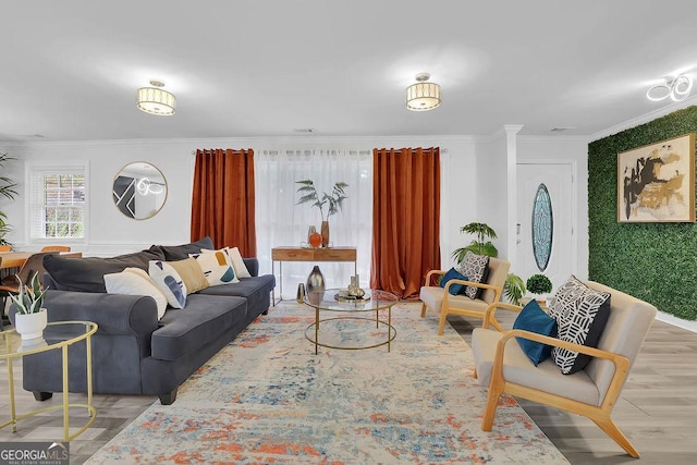 living room with hardwood / wood-style flooring and ornamental molding