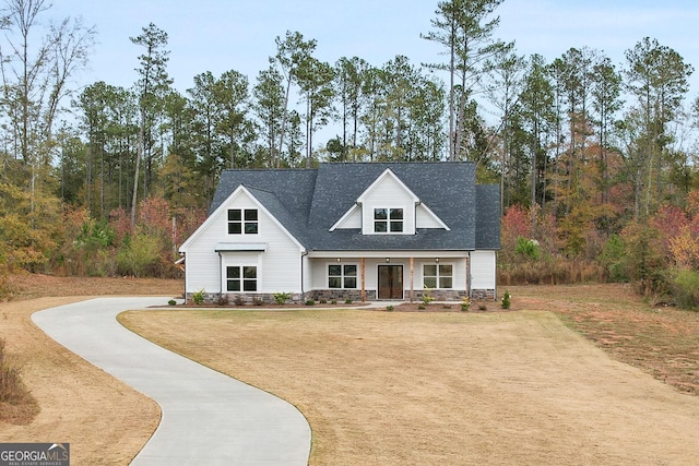 view of front of house with a front yard and a porch