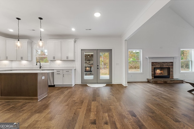 kitchen with hanging light fixtures, white cabinetry, dark hardwood / wood-style floors, and decorative backsplash