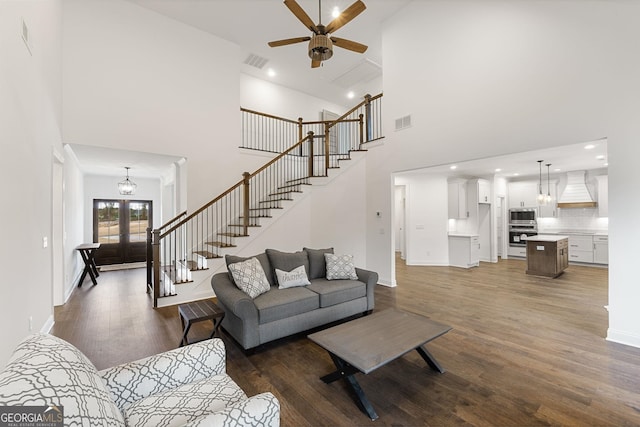 living room featuring dark wood-type flooring, ceiling fan, and french doors