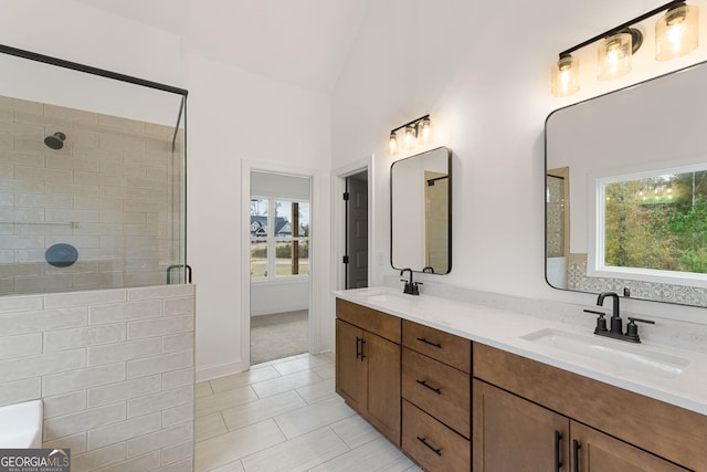 bathroom featuring lofted ceiling, vanity, a shower with door, and tile patterned floors