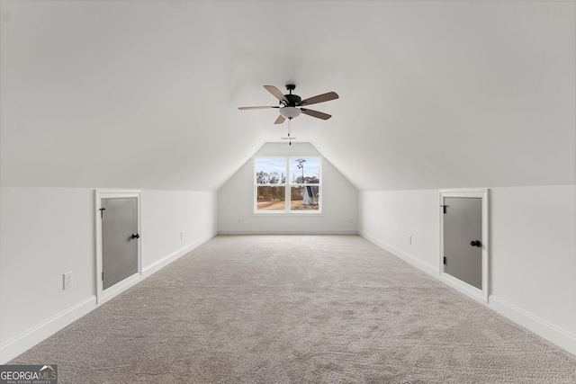 additional living space with lofted ceiling, light colored carpet, and ceiling fan