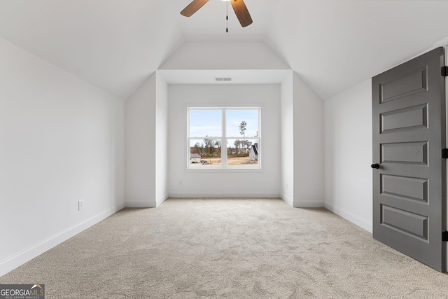 additional living space with lofted ceiling, light colored carpet, and ceiling fan