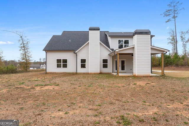 back of property with ceiling fan, a patio area, and a lawn