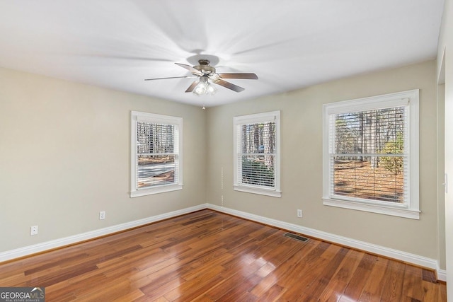 spare room featuring wood-type flooring and ceiling fan