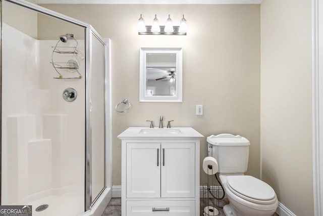 bathroom with toilet, vanity, and a shower with shower door