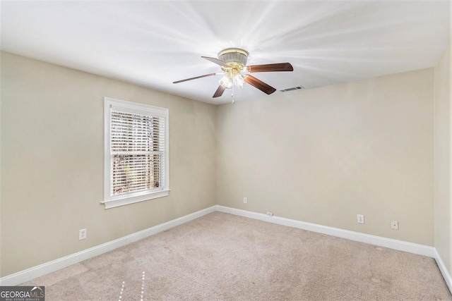 carpeted empty room featuring ceiling fan