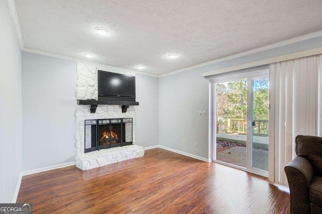 living room with hardwood / wood-style flooring, a fireplace, and ornamental molding