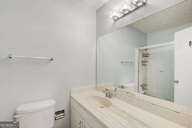 full bathroom with vanity, enclosed tub / shower combo, and toilet