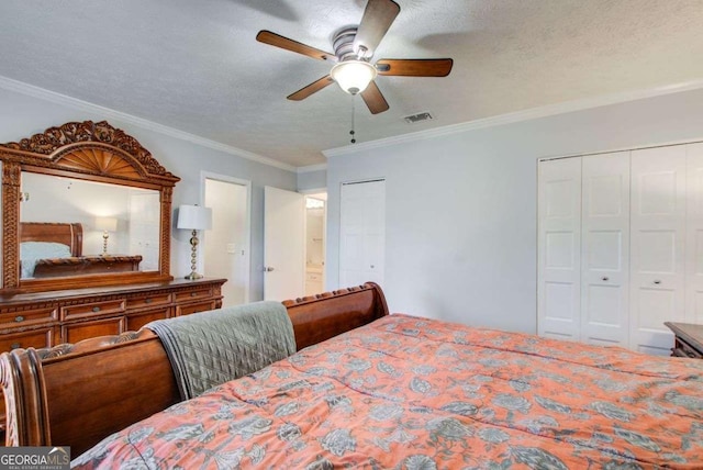 bedroom with ornamental molding, two closets, ceiling fan, and a textured ceiling