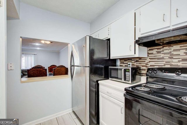 kitchen with appliances with stainless steel finishes, white cabinetry, range hood, tasteful backsplash, and light wood-type flooring