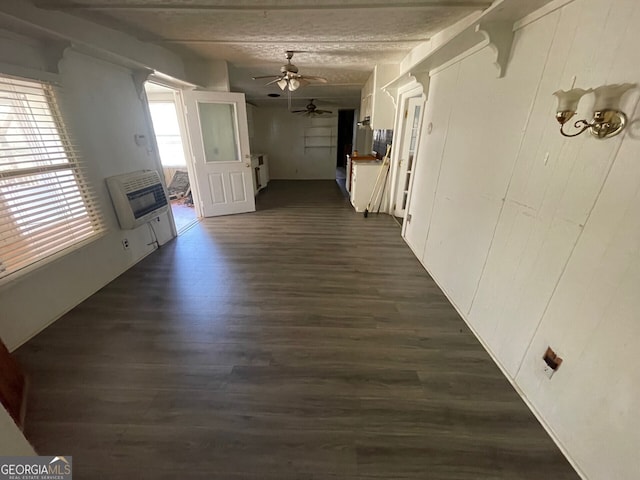 hallway with heating unit and dark hardwood / wood-style flooring