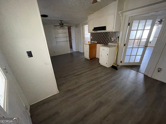 kitchen with white cabinetry, ceiling fan, dark hardwood / wood-style floors, and decorative backsplash