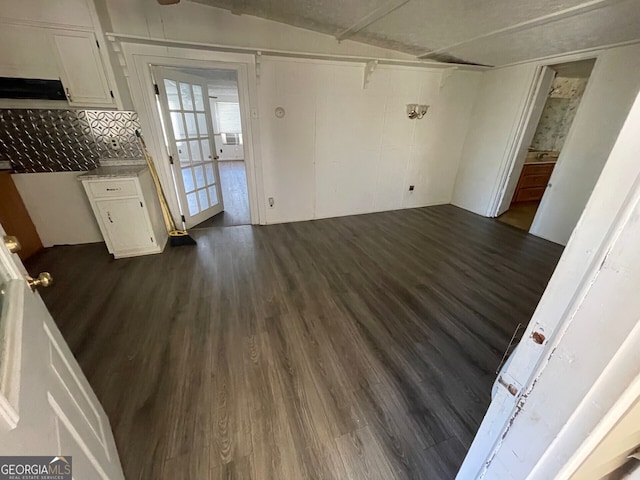 unfurnished living room featuring dark hardwood / wood-style floors