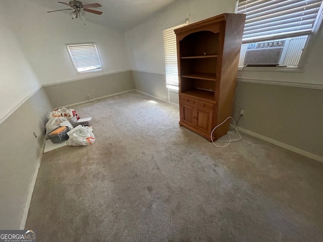 interior space with multiple windows, lofted ceiling, and carpet