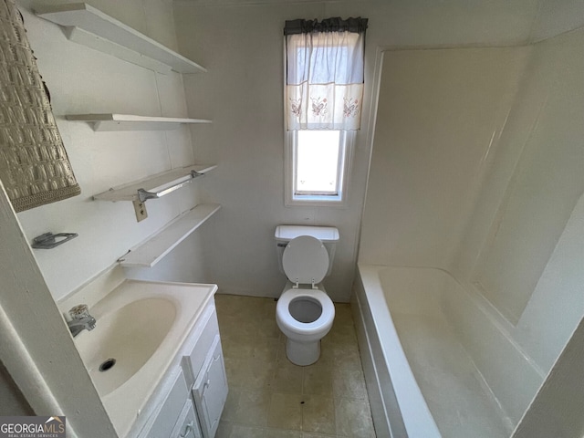 bathroom featuring tile patterned flooring, vanity, and toilet