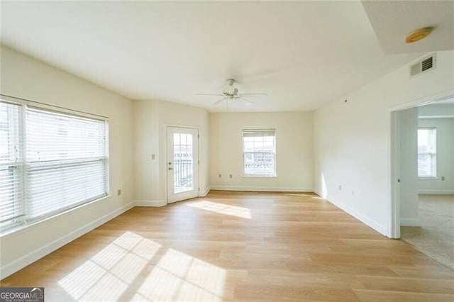 empty room with light hardwood / wood-style flooring and ceiling fan