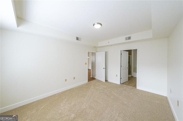 unfurnished bedroom featuring light carpet