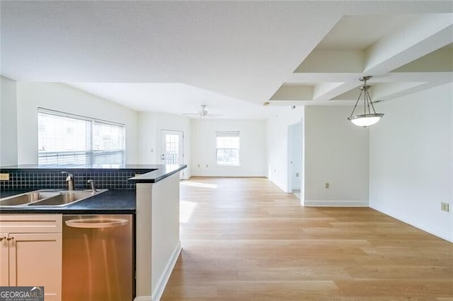 kitchen with pendant lighting, sink, dishwasher, ceiling fan, and light hardwood / wood-style floors