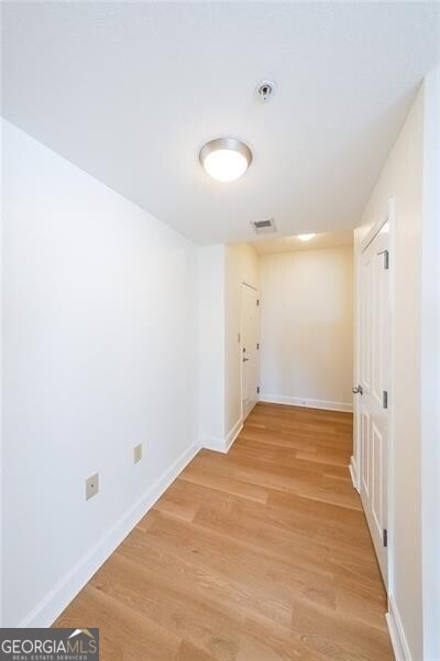 hall with hardwood / wood-style floors