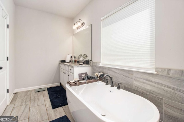 bathroom with vanity and a tub to relax in