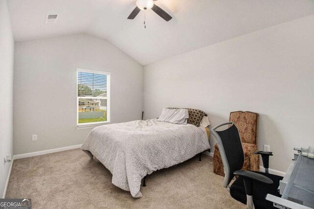 bedroom featuring vaulted ceiling, light carpet, and ceiling fan