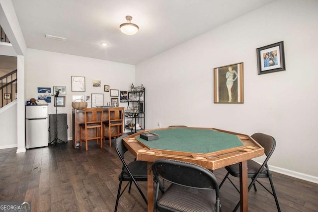 playroom with dark wood-type flooring