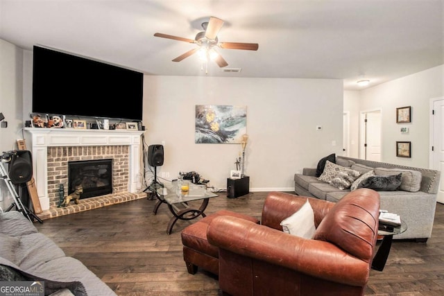 living room with ceiling fan, dark hardwood / wood-style flooring, and a brick fireplace