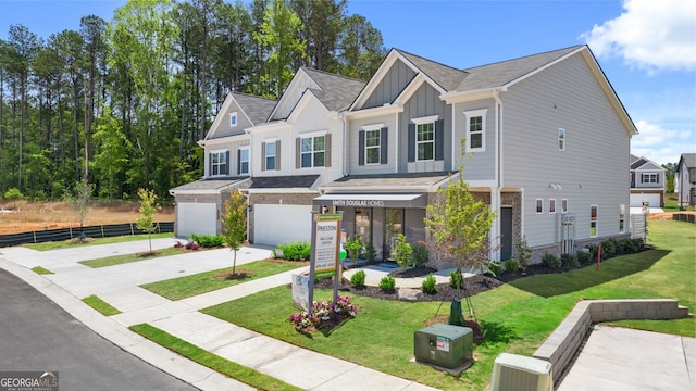 view of front of house featuring a garage and a front lawn