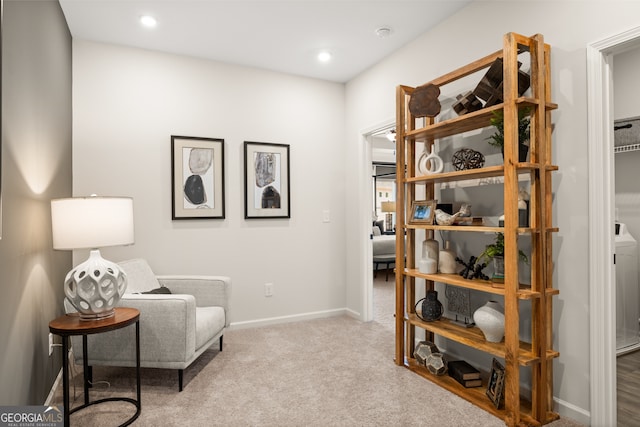 sitting room featuring light colored carpet