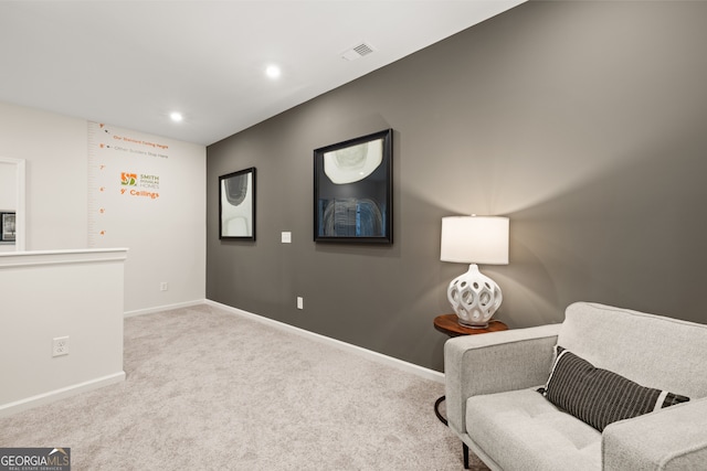 living area with light colored carpet