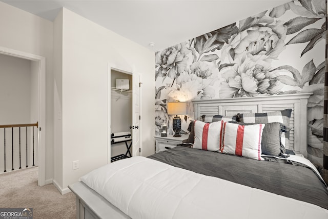 bedroom featuring a fireplace, light colored carpet, and a closet