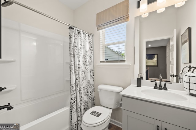 full bathroom featuring vanity, shower / bathtub combination with curtain, and toilet