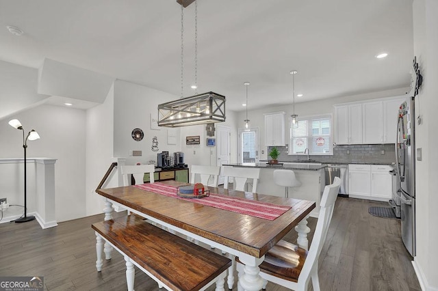 dining space with dark hardwood / wood-style flooring and sink