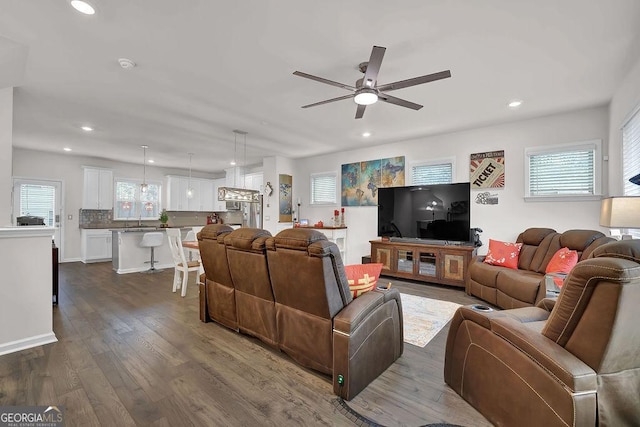 living room featuring ceiling fan, dark hardwood / wood-style flooring, and sink