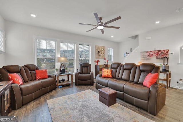 living room with ceiling fan and hardwood / wood-style floors